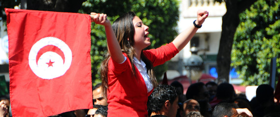 A woman waves a national flag during a demonstration to celebrate Tunisia's independence, Tuesday, March, 20, 2012 in Tunis. On March 20, 1956, Tunisia achieved independence from France proposed by Habib Bourguiba, who became the first President of the Republic of Tunisia. (AP Photo/Hassene Dridi)